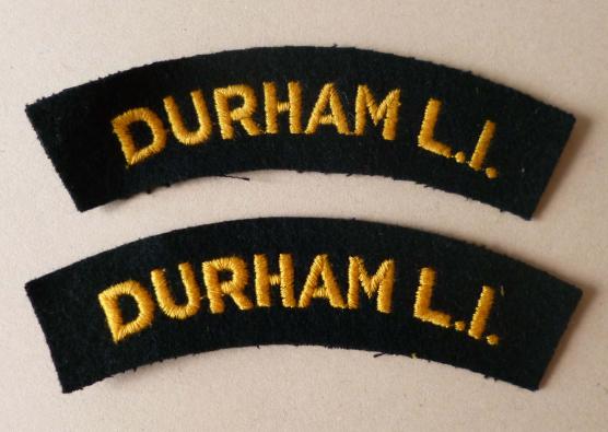 Pair of Durham Light Infantry 'Durham L.I.' machine-embroidered cloth shoulder titles.
