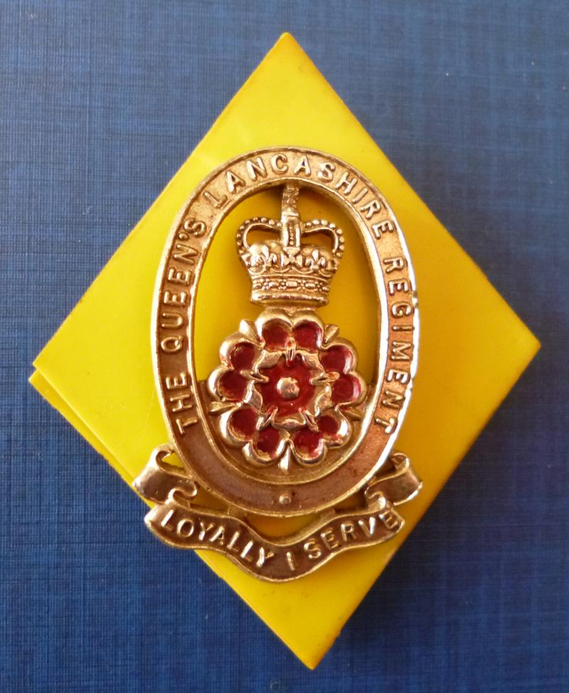 The Queen's Lancashire Regiment Cap-badge with backing.