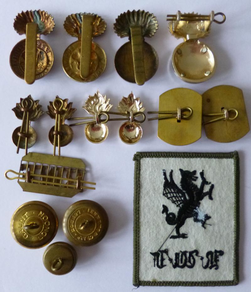 Royal Welch Fusiliers Grouping of Eleven Badges, One TRF & Three Buttons.